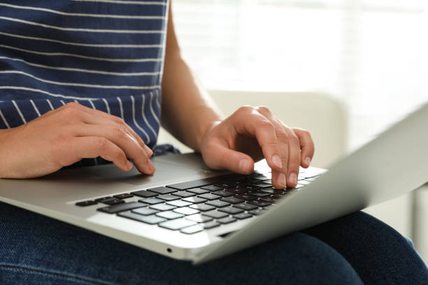 istock Young woman using laptop for search indoors, closeup 1386935134