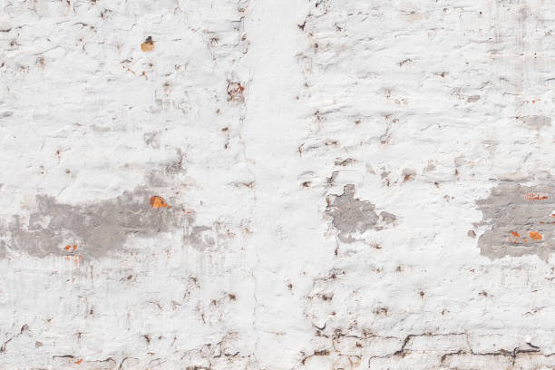 istock Texture of old brick wall with weather worn surface as background 1386935330