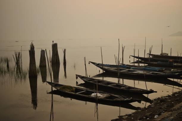 istock fishing boats and poles 1386938009