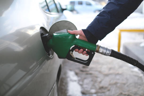 Green Fuel Drop From Gas Pump Nozzle Isolated on White. 3D Render