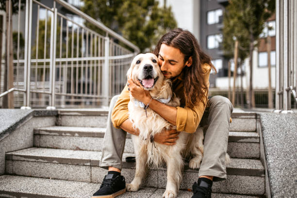 istock Man embracing with his cute dog 1386938931