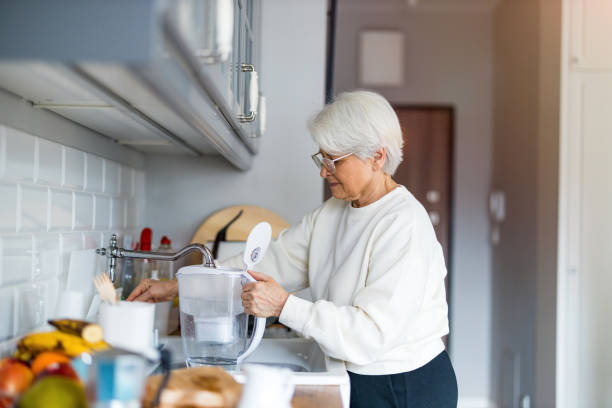 Shot of a senior woman in her kitchen stock photo