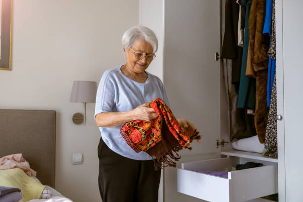 Senior woman tiding up her wardrobe stock photo