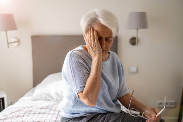 istock Senior woman suffering from a headache 1386939382