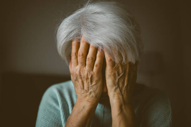 seniorin bedeckt gesicht mit ihren händen - hands in head stock-fotos und bilder