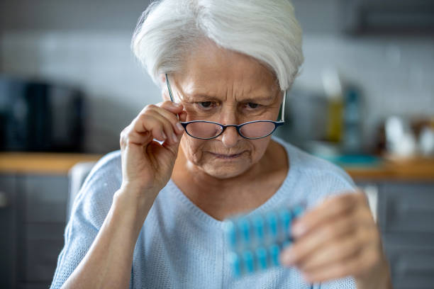 Senior woman about to take her medication stock photo