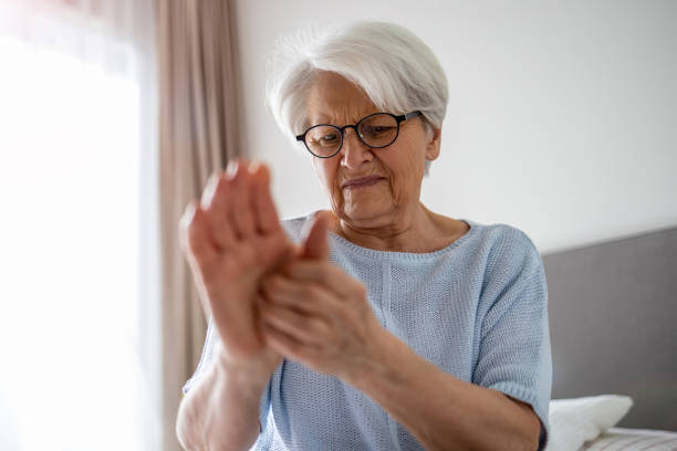 istock Senior woman with arthritis rubbing hands 1386939430