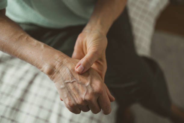 istock Senior woman with arthritis rubbing hands 1386939459