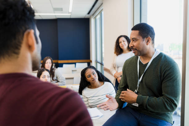 Tutor addresses the class The class tutor addresses the group while answering the question of a student. role model stock pictures, royalty-free photos & images