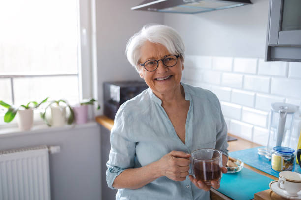 Portrait of senior woman smiling at home stock photo