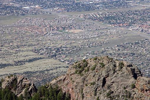 Aerial view of Albuquerque, New Mexico's urban sprawl up against the foothills of the Sandia Mountains