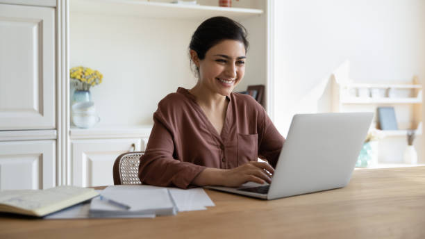 istock Happy millennial indian businesswoman working on computer. 1386942563