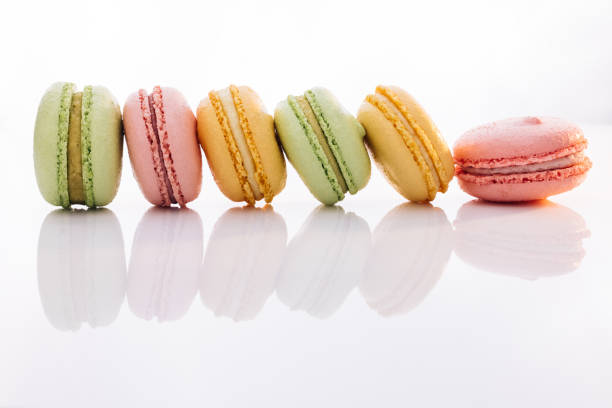 istock Colorful macarons dessert. French macarons on white background. Different colorful macaroon. Tasty sweet color macaron 1386942920