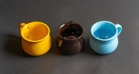 Set of colorful coffee mugs on Black background