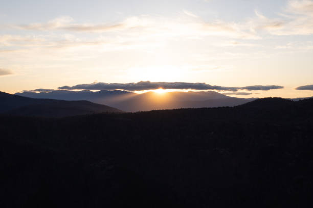 Sun Setting over Mountain Ridge in North Carolina Mountains Sun setting over Mt. Mitchell and the Black Mountain Crest, seen from the Linville Gorge in Western North Carolina. mt mitchell stock pictures, royalty-free photos & images