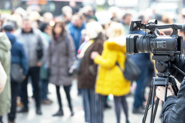 Filming crowd of people with a video camera stock photo