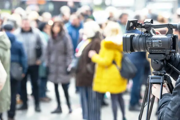 Photo of Filming crowd of people with a video camera