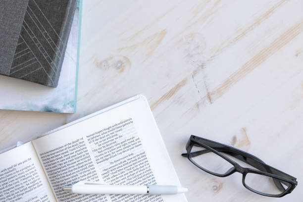 istock Open bible with journal and glasses 1386946915