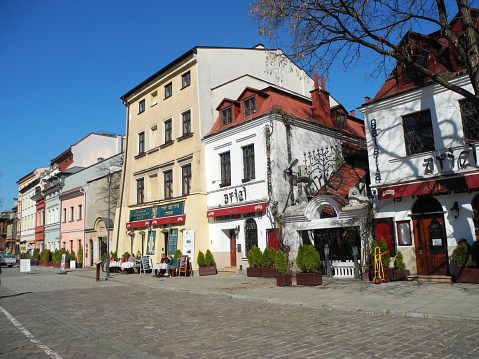 Krakow, Poland - March 21, 2022: View to Szeroka street  with cafes and restaurants in old Jewish quarter Kazimierz