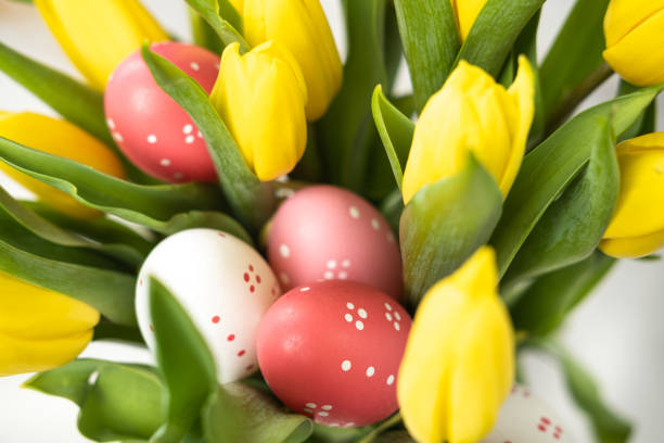 Bunch of yellow tulips and Easter eggs close up.