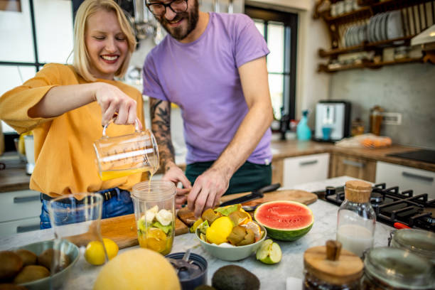 istock Young couple preparing healthy meal 1386949798