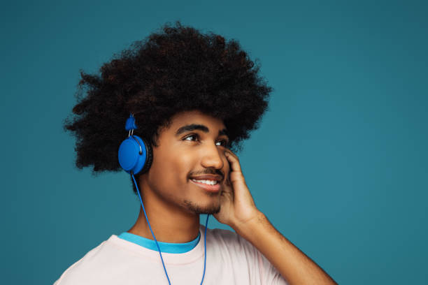 istock African american man with african hairstyle using phone 1386950683