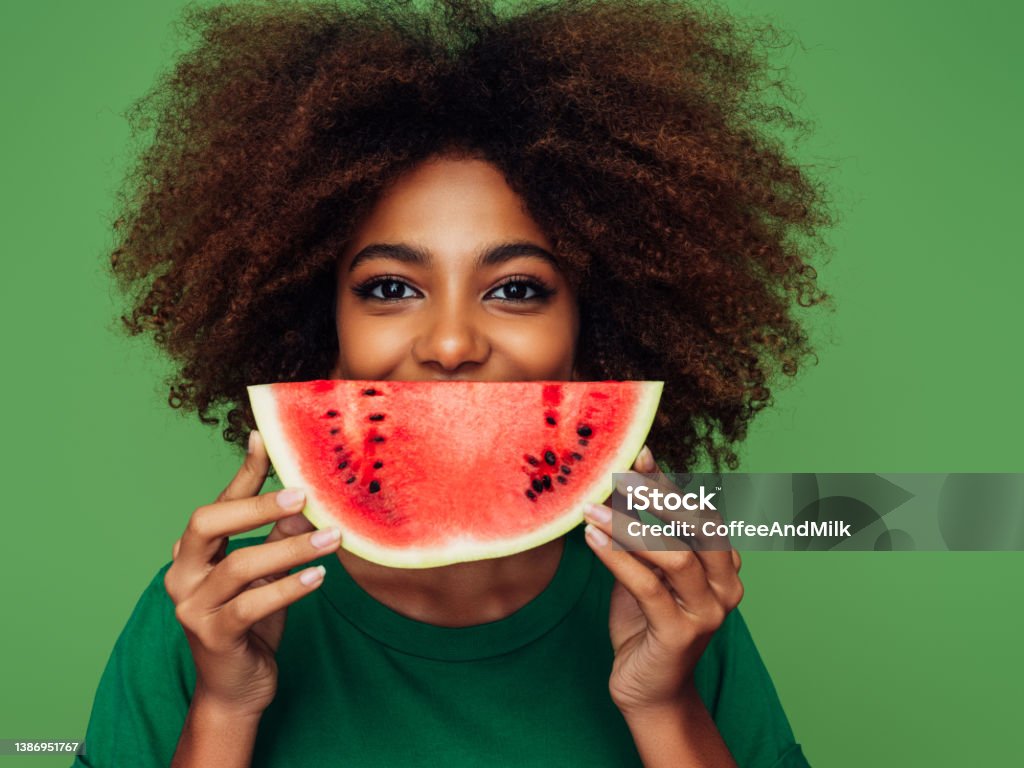 Studio portrait of a beautiful afro girl with watermelon Watermelon Stock Photo