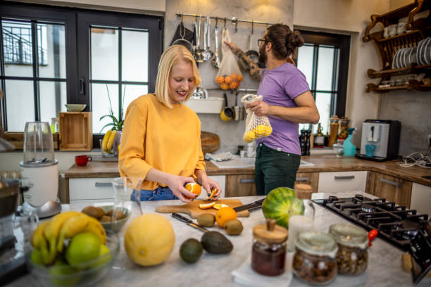 istock Young couple making breakfast at home 1386951865