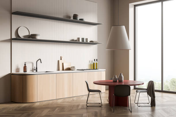 istock Modern dining room interior, large red table with 4 chairs. Stylish kitchen. hardwood flooring. Open space area. 3d rendering. 1386952989