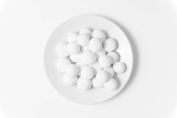 istock White sugar balls in a white saucer on a white background. Close up top view. 1386953331