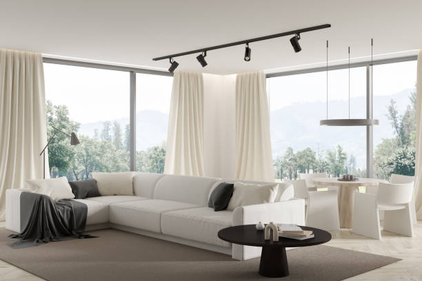 istock Empty bright living room interior with big couch, table, coffee table, panoramic windows view, hardwood flooring. Concept of minimalist design. New park villa real estate. Creative idea. 3d rendering 1386954488