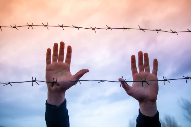 istock Refugees and the fence 1386959287