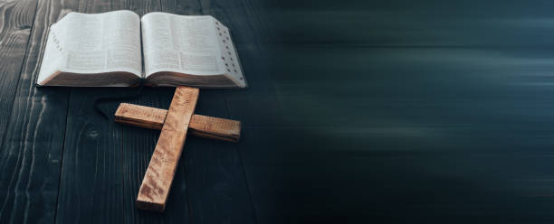 istock Holy Bible with wooden cross 1386959291