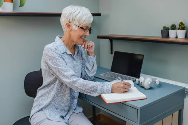 istock Senior woman working at home office 1386959341