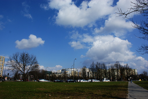 public park with no trees in the center of a city Warsaw Poland blue sky and clouds