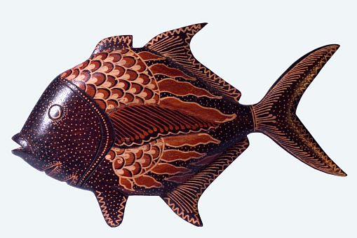 The application of batik to fish sculptures made of wood is used to decorate room interior.