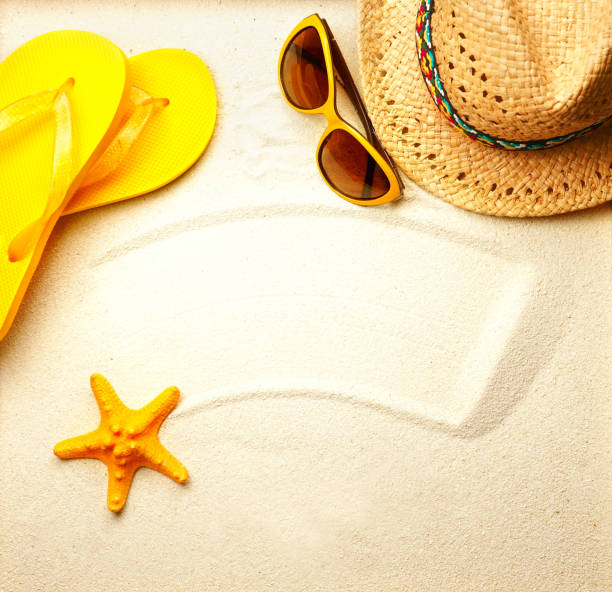 istock Straw hat, sunglasses, beach flip-flops and starfish on the sand. 1386960523