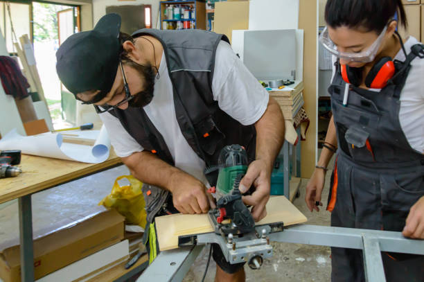 istock A Young Female Carpenter is Using a Sander Machine in a Workshop with Assistance of a Male Colleague. 1386961380
