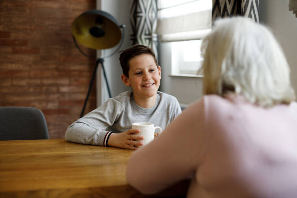 istock Boy speaking and sharing secret with grandmother 1386962018