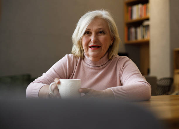 istock Grandmother talking with her grandson while drinking tea. 1386962021