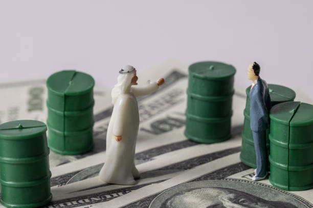 istock Stack Image of Arab Saudi man with USD noted with oils barrel. Crude oil commodity trading in price crisis situation. 1386964256
