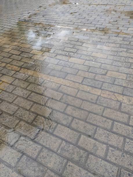 istock Concrete blocks floor covered in water after the rain 1386971077