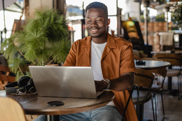 istock Smiling multi - ethnic man enjoying at coffee shop 1386971304
