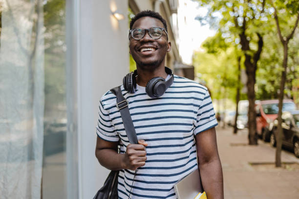 istock Stylish man walking along city streets 1386971916