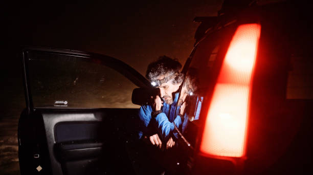 istock Man with car issues on winter road, phone calling for help. 1386973608