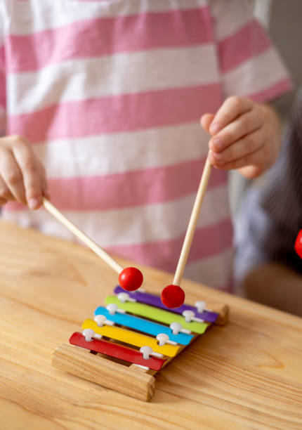 istock Montessori material. Home education. Mom and daughter are learning musical instruments. 1386976280