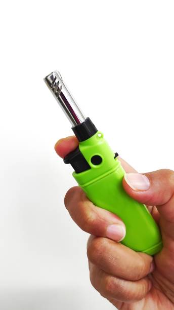 istock Green  gas lighter on a white background 1386983024