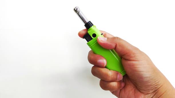 istock Green  gas lighter on a white background 1386983038