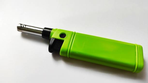 istock Green  gas lighter on a white background 1386983041
