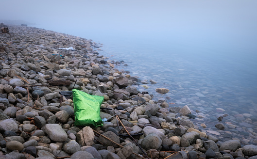 A green balloon is discard along the Detroit River following St. Patrick's Day celebrations.